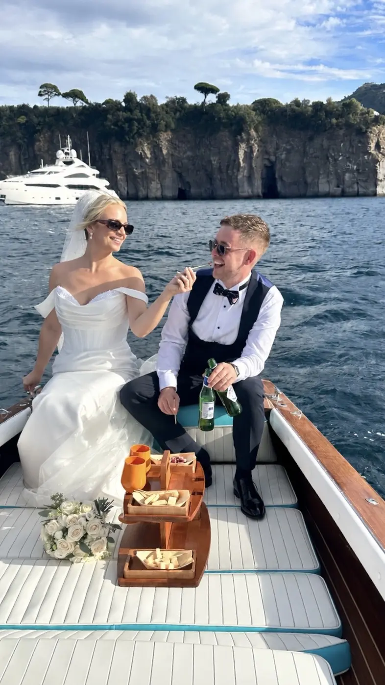 Newlyweds enjoying a private Riva boat experience on the Sorrento Coast